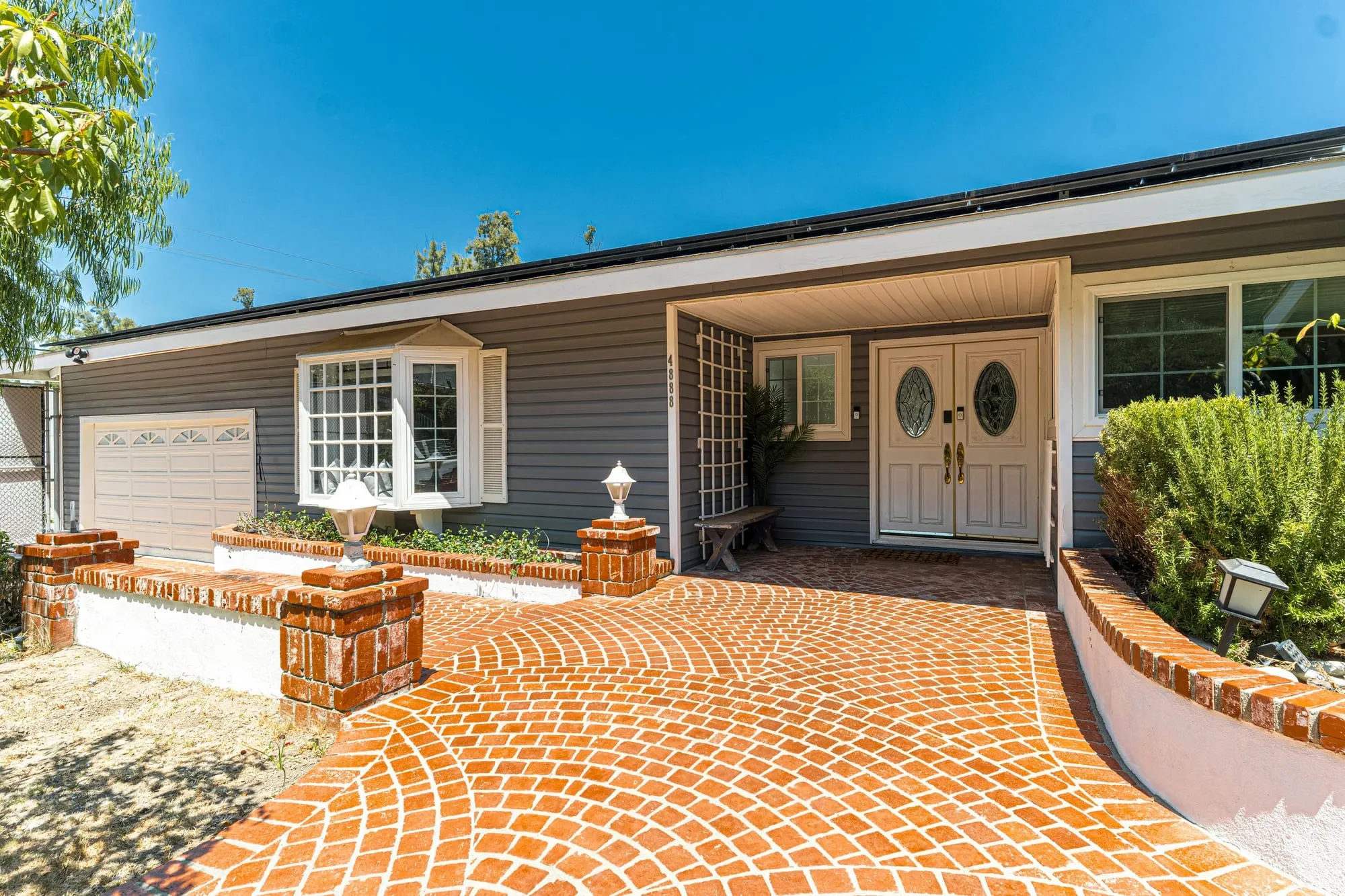 Curved brick-paver driveway and walkway