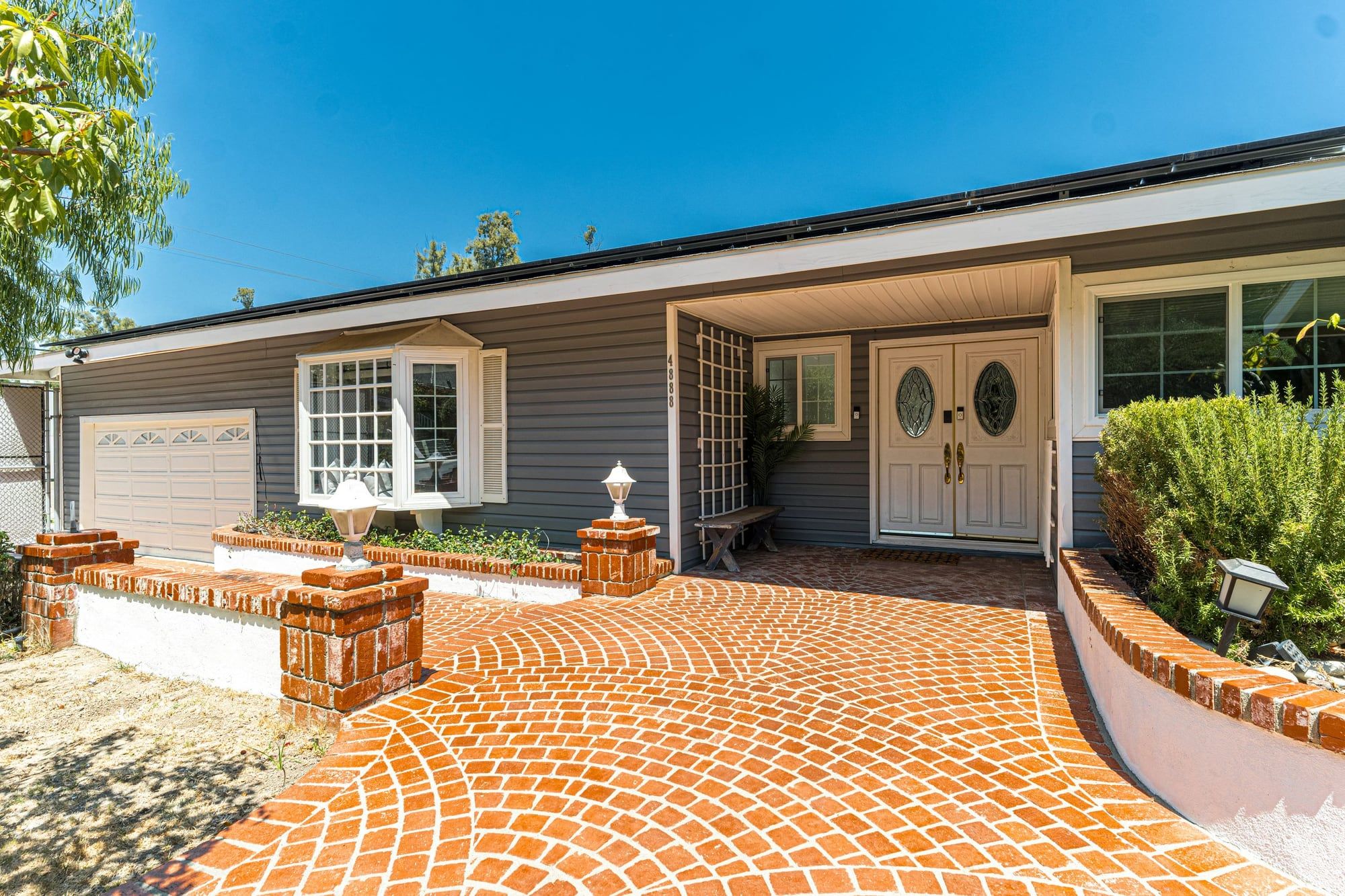 Sealed brick-tone paver driveway with rich, even color